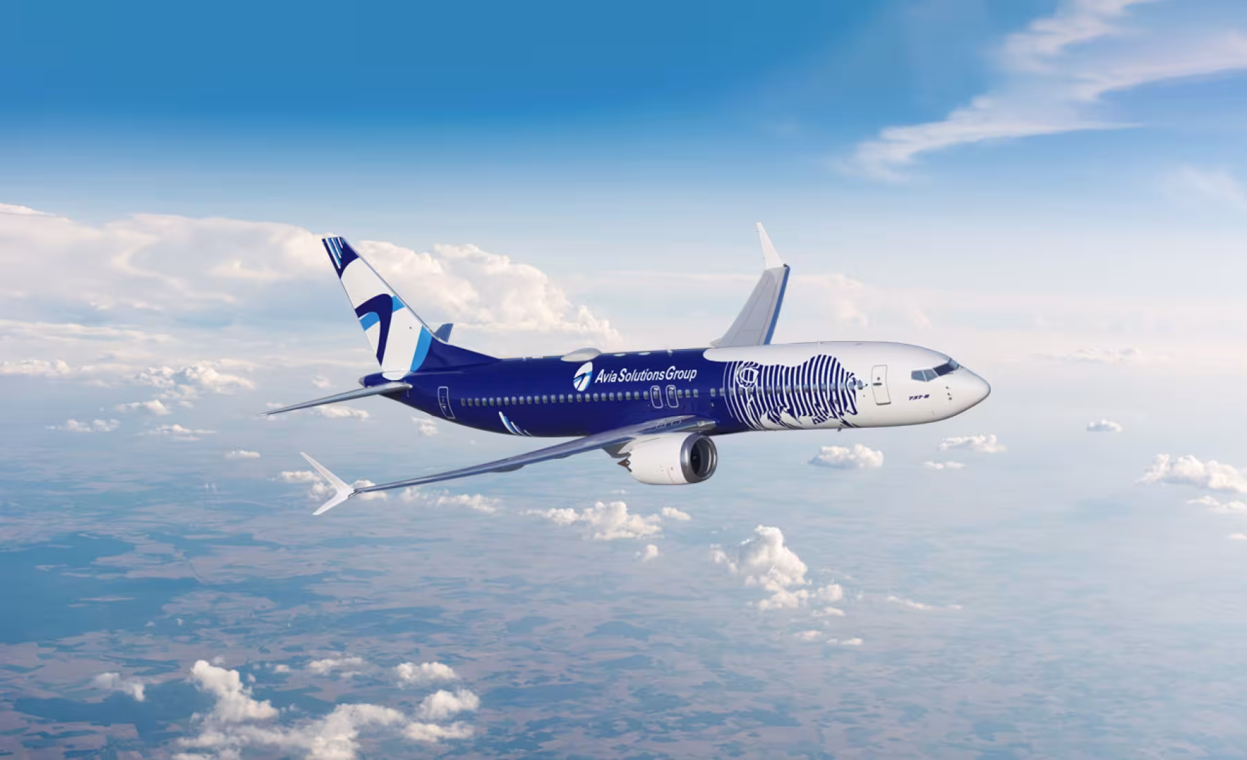 A Boeing 737 in Avia Solutions Group livery, featuring a dark blue fuselage with a white-blue zebra design. The aircraft flies against a bright sky with scattered clouds and landscape below.