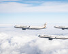 Three STARLUX Airlines aircraft flying in formation above the clouds under a blue sky.